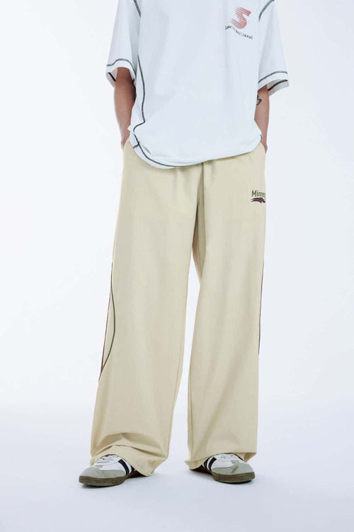 Curved-Panel Graphic Wide-Leg Pants in Light Khaki - front modeled view