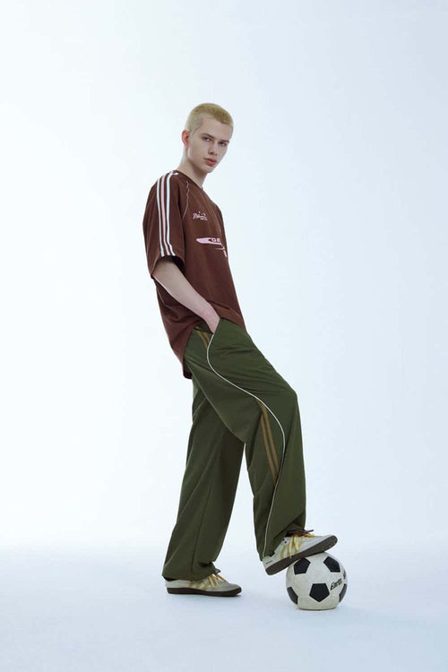 Curved-Panel Graphic Wide-Leg Pants in Military Green - full-length front modeled view
