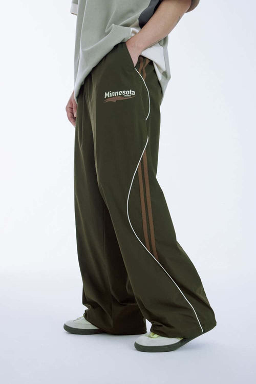 Curved-Panel Graphic Wide-Leg Pants in Military Green - side modeled view
