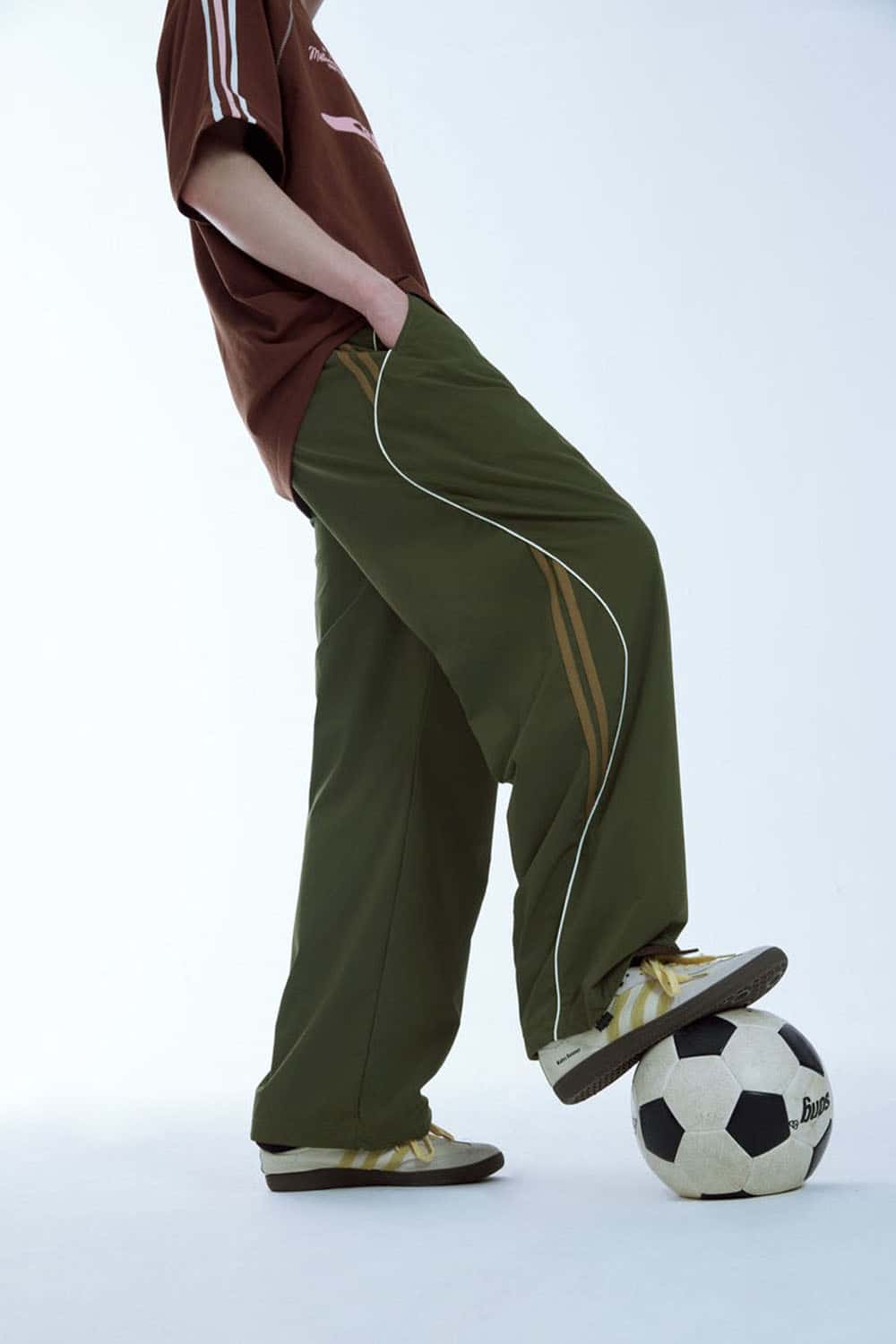 Curved-Panel Graphic Wide-Leg Pants in Military Green - front modeled view