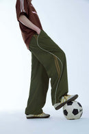 Curved-Panel Graphic Wide-Leg Pants in Military Green - front modeled view