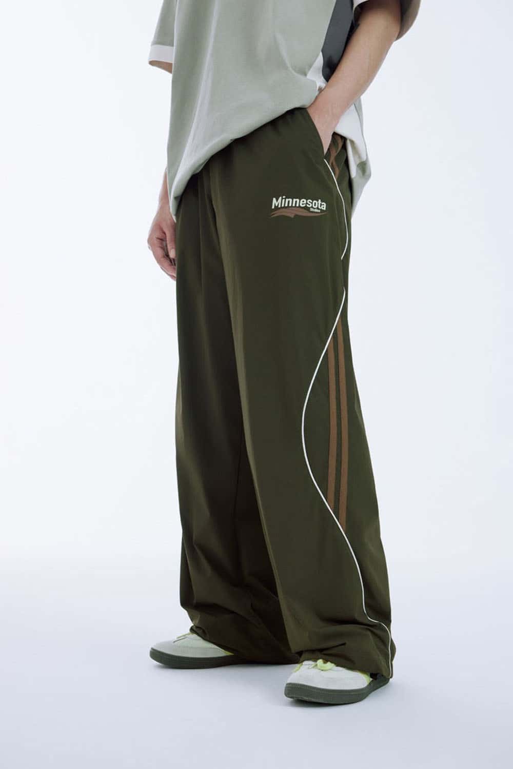 Curved-Panel Graphic Wide-Leg Pants in Military Green - front modeled view
