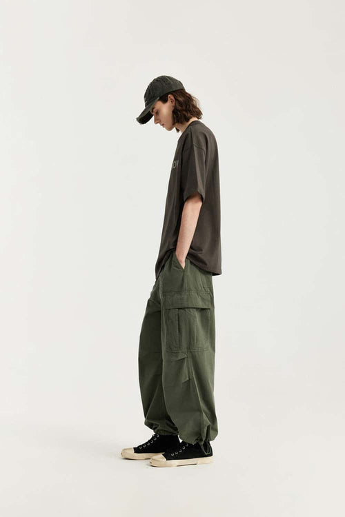 Breathable Washed Wide-Leg Cotton Cargo Pants in Military Green - full-length side modeled view