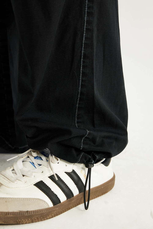 Washed Slub Cotton Wide-Leg Trousers in Black - product detail close-up