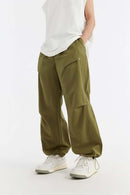 Double-Pleated Rivet-Detail Wide-Leg Cargo Pants in Green - front modeled view