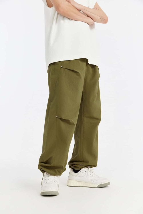 Double-Pleated Rivet-Detail Wide-Leg Cargo Pants in Green - front modeled view