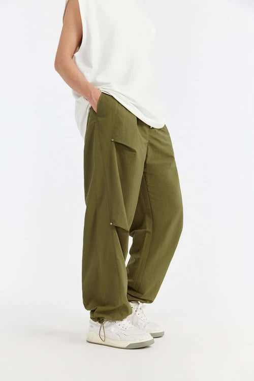 Double-Pleated Rivet-Detail Wide-Leg Cargo Pants in Green - front modeled view