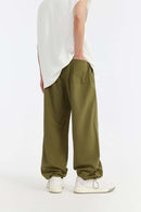 Double-Pleated Rivet-Detail Wide-Leg Cargo Pants in Green - back modeled view