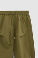 Double-Pleated Rivet-Detail Wide-Leg Cargo Pants in Green - front modeled view