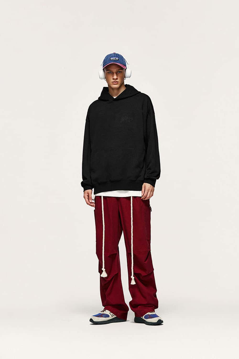 Embroidered Vertical-Rib Relaxed Pullover Hoodie in Black - full-length front modeled view