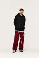 Embroidered Vertical-Rib Relaxed Pullover Hoodie in Black - full-length front modeled view