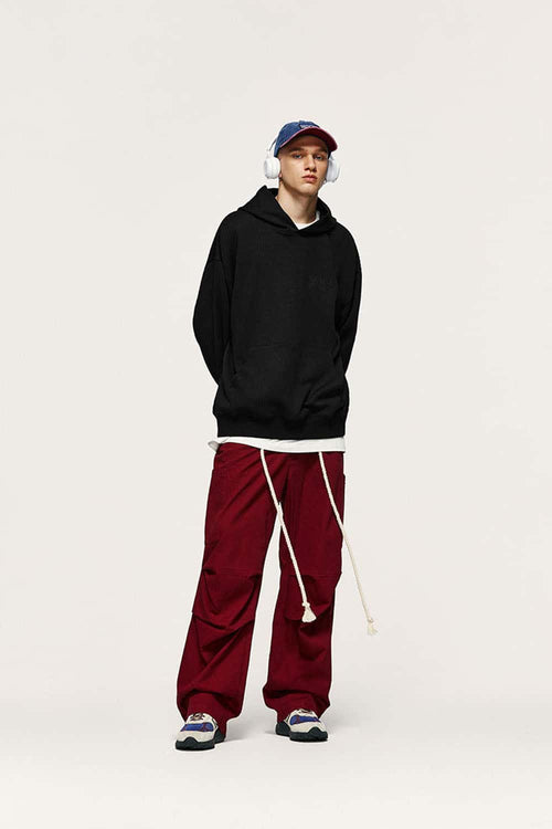 Embroidered Vertical-Rib Relaxed Pullover Hoodie in Black - full-length front modeled view