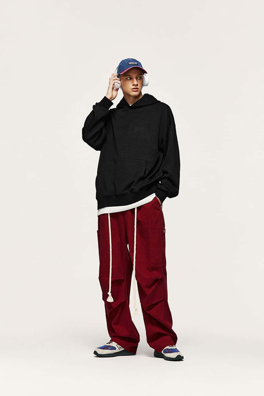Embroidered Vertical-Rib Relaxed Pullover Hoodie in Black - full-length front modeled view