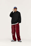 Embroidered Vertical-Rib Relaxed Pullover Hoodie in Black - full-length front modeled view
