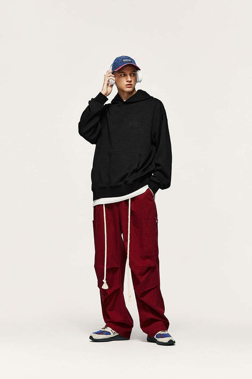 Embroidered Vertical-Rib Relaxed Pullover Hoodie in Black - full-length front modeled view