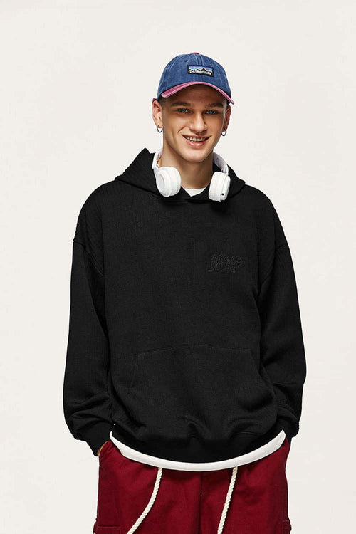 Embroidered Vertical-Rib Relaxed Pullover Hoodie in Black - front modeled view