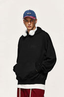 Embroidered Vertical-Rib Relaxed Pullover Hoodie in Black - three-quarter front modeled view