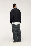 Washed Cotton Wide-Leg Carpenter Pants in Black - full-length back modeled view