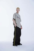 Striped Drawstring Loose Parachute Pants in Black - three-quarter front modeled view