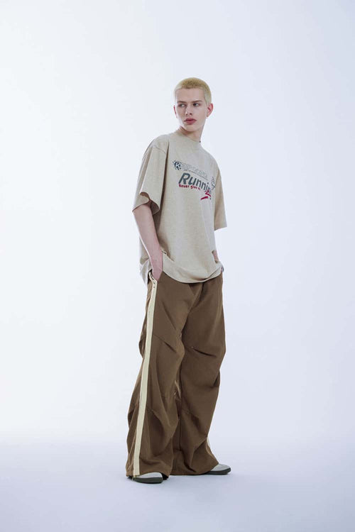 Striped Drawstring Loose Parachute Pants in Brown - three-quarter front modeled view