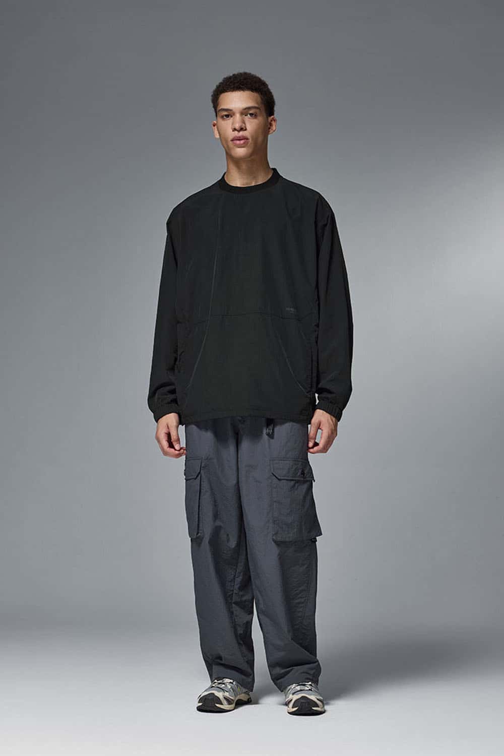 Utility Pocket Nylon Long-Sleeve Pullover in Black - full-length front modeled view