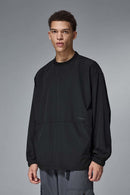 Utility Pocket Nylon Long-Sleeve Pullover in Black - front modeled close-up