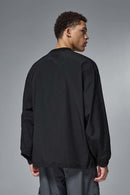 Utility Pocket Nylon Long-Sleeve Pullover in Black - rear three-quarter modeled view