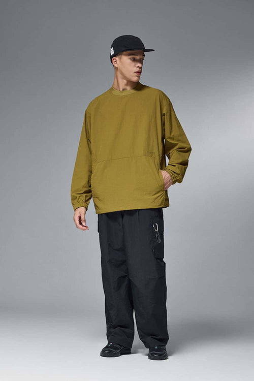 Utility Pocket Nylon Long-Sleeve Pullover in Green - full-length front modeled view