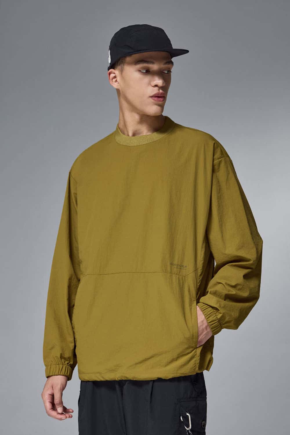 Utility Pocket Nylon Long-Sleeve Pullover in Green - front modeled close-up
