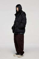 Packable White Duck Down Hooded Puffer Jacket in Black - full-length side modeled view