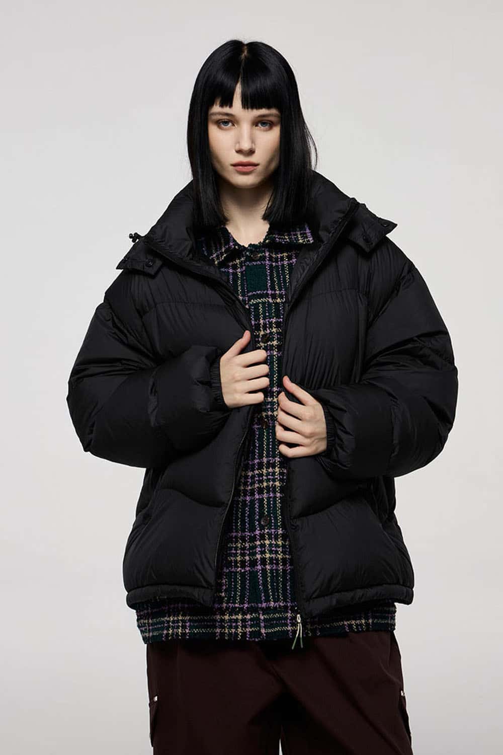Packable White Duck Down Hooded Puffer Jacket in Black - front modeled close-up