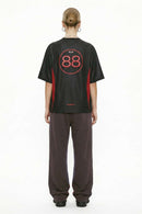 Mesh-Panel Graphic Raglan Tee in Black - full-length back modeled view