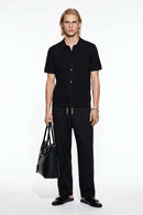 Button-Front Short-Sleeve Knit Shirt in Black - full-length front modeled view