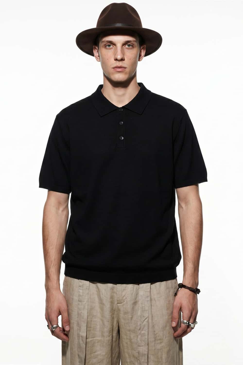 Relaxed Cotton Knit Polo Shirt in Black - front modeled view