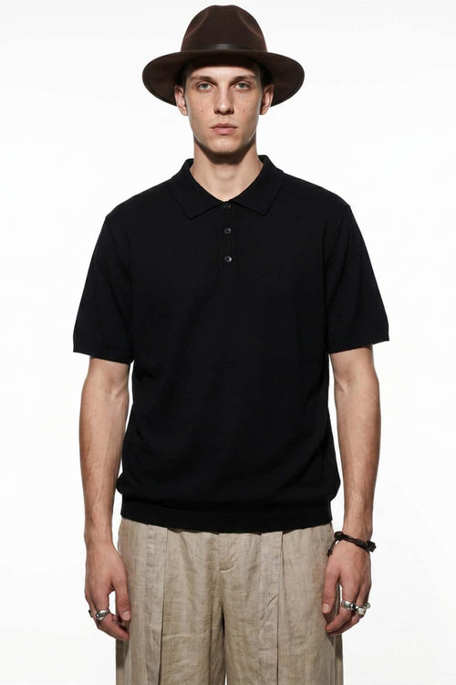 Relaxed Cotton Knit Polo Shirt in Black - front modeled view
