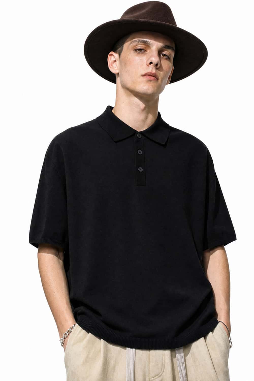 Relaxed Cotton Knit Polo Shirt in Black - front modeled view