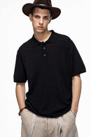 Relaxed Cotton Knit Polo Shirt in Black - front modeled view