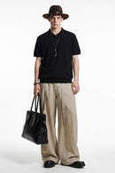 Relaxed Cotton Knit Polo Shirt in Black - full-length front modeled view