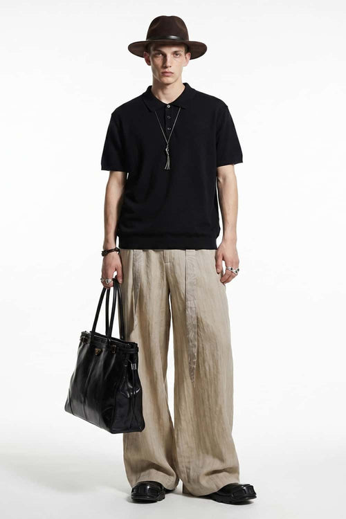 Relaxed Cotton Knit Polo Shirt in Black - full-length front modeled view