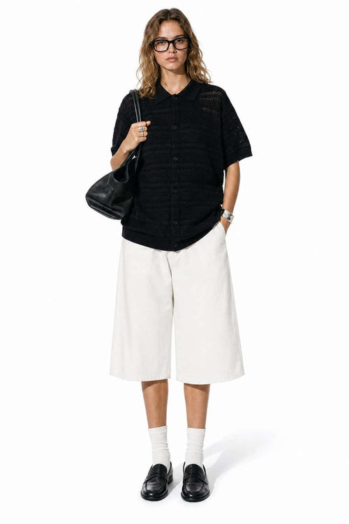 Short-Sleeve Knit Cardigan with Openwork Bands in Black - full-length front modeled view