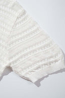 Short-Sleeve Knit Cardigan with Openwork Bands in White - fabric texture close-up
