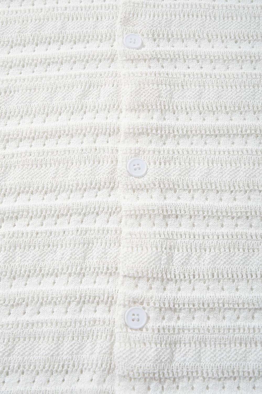 Short-Sleeve Knit Cardigan with Openwork Bands in White - fabric texture close-up