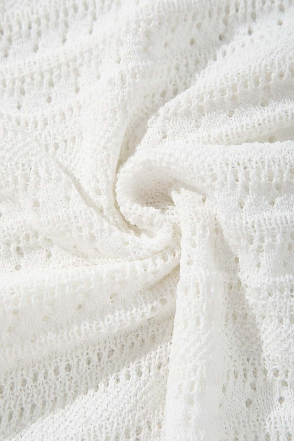 Short-Sleeve Knit Cardigan with Openwork Bands in White - fabric texture close-up