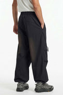 Waterproof Wide-Leg Pants with Drawstring Waist in Black - rear three-quarter modeled view
