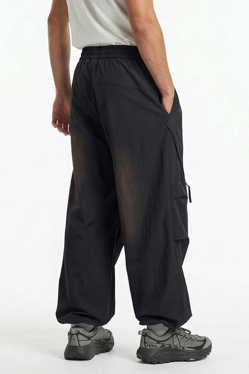 Waterproof Wide-Leg Pants with Drawstring Waist in Black - rear three-quarter modeled view