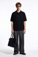 Textured Short-Sleeve Knit Shirt in Black - full-length front modeled view