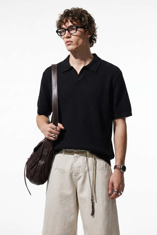 Open-Neck Textured Knit Polo in Black - front modeled close-up