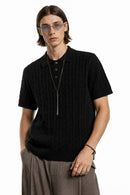 Cable-Knit Short-Sleeve Polo in Black - front modeled close-up