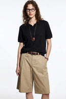 Open-Neck Knit Polo with Raised Stripes in Black - full-length front modeled view