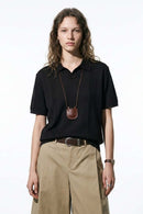 Open-Neck Knit Polo with Raised Stripes in Black - full-length front modeled view